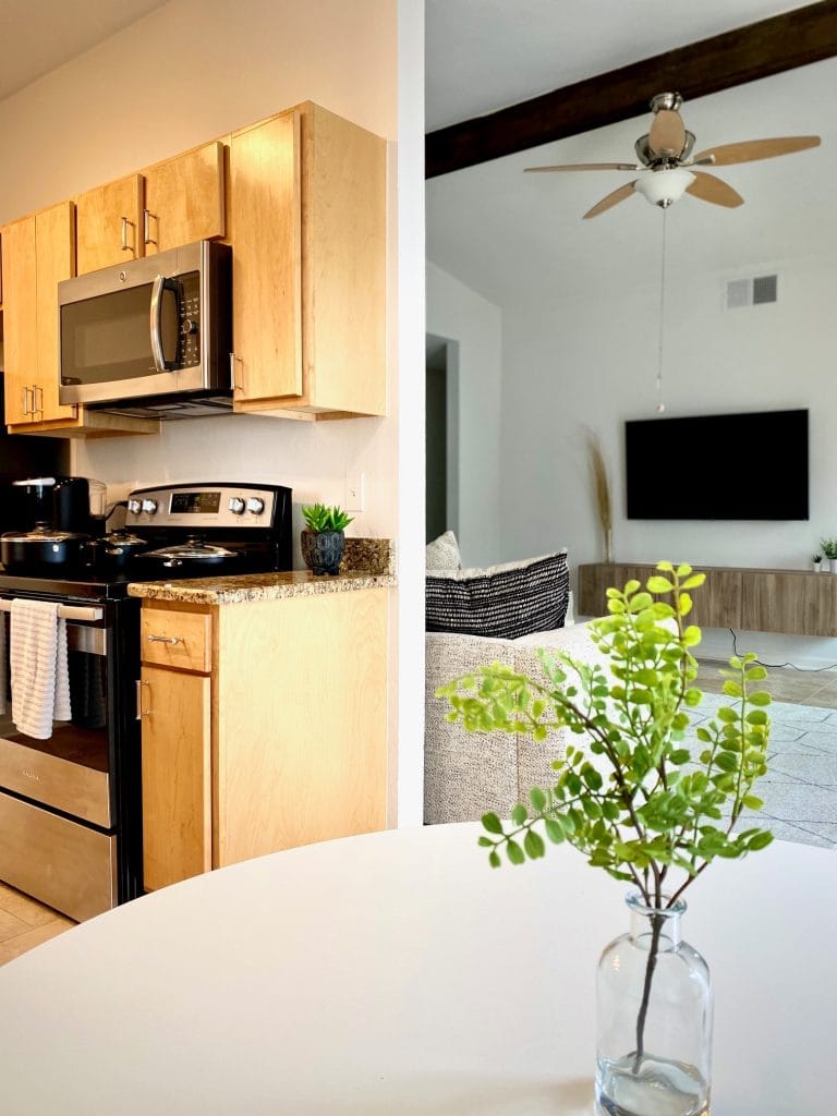 Modern kitchen with sleek appliances adjoins a cozy living area, perfect for relaxation and focused work | Dream TDY