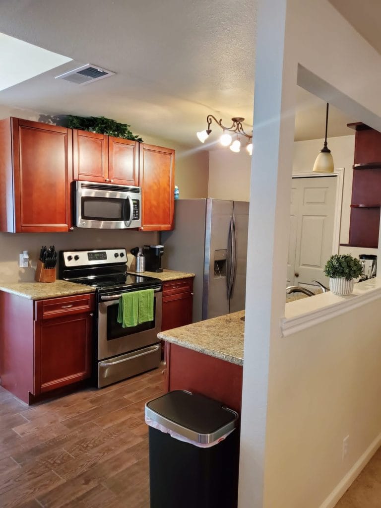 Modern kitchen with stainless appliances, granite countertops, ample storage, and a clean, inviting atmosphere for meal prep | Dream TDY