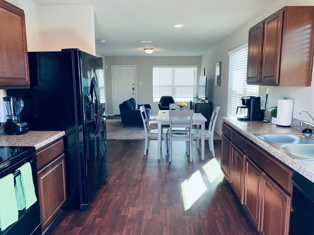 Inviting open kitchen with modern appliances, spacious dining area, and cozy living space for relaxation | Dream TDY