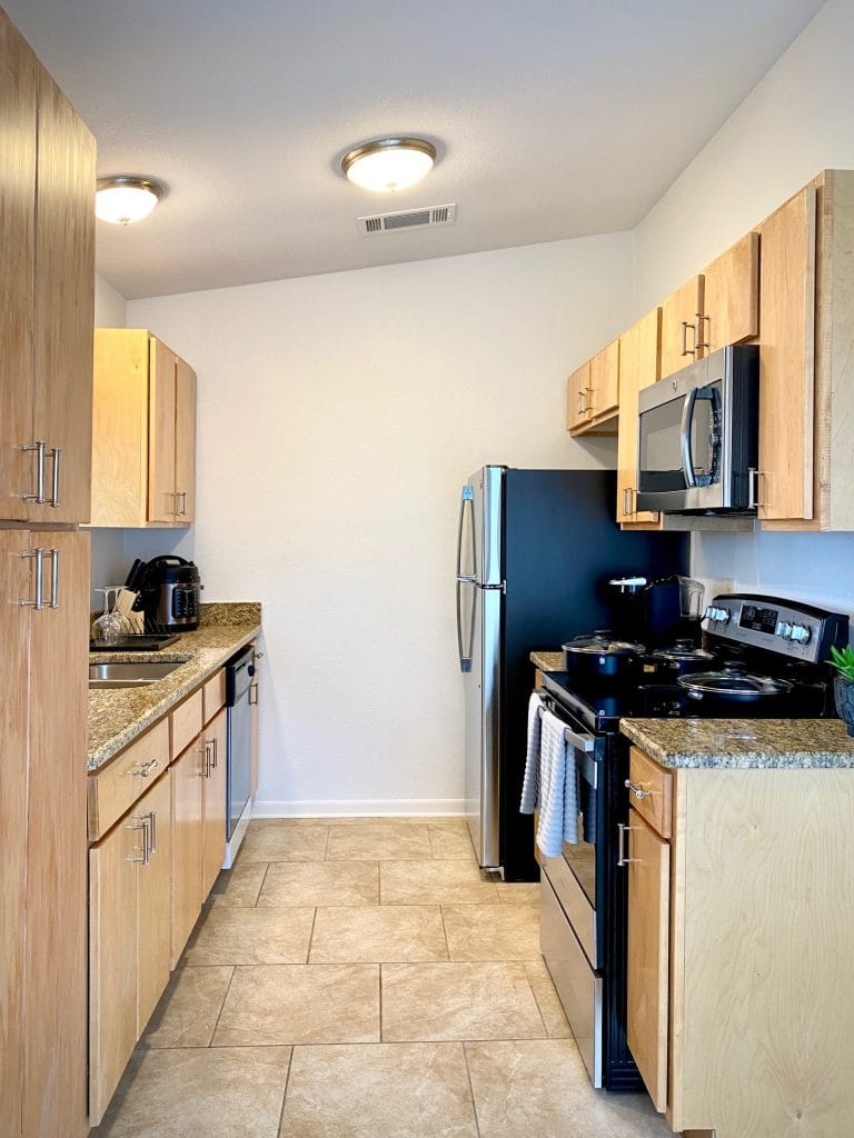 Modern kitchen with sleek appliances, granite countertops, and ample storage; perfect for quick meal prep | Dream TDY