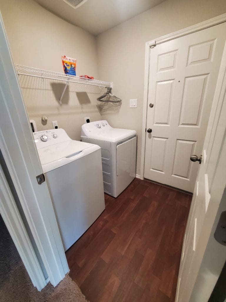 Convenient laundry room featuring modern appliances, ample storage, and a tidy environment for your ease of use | Dream TDY