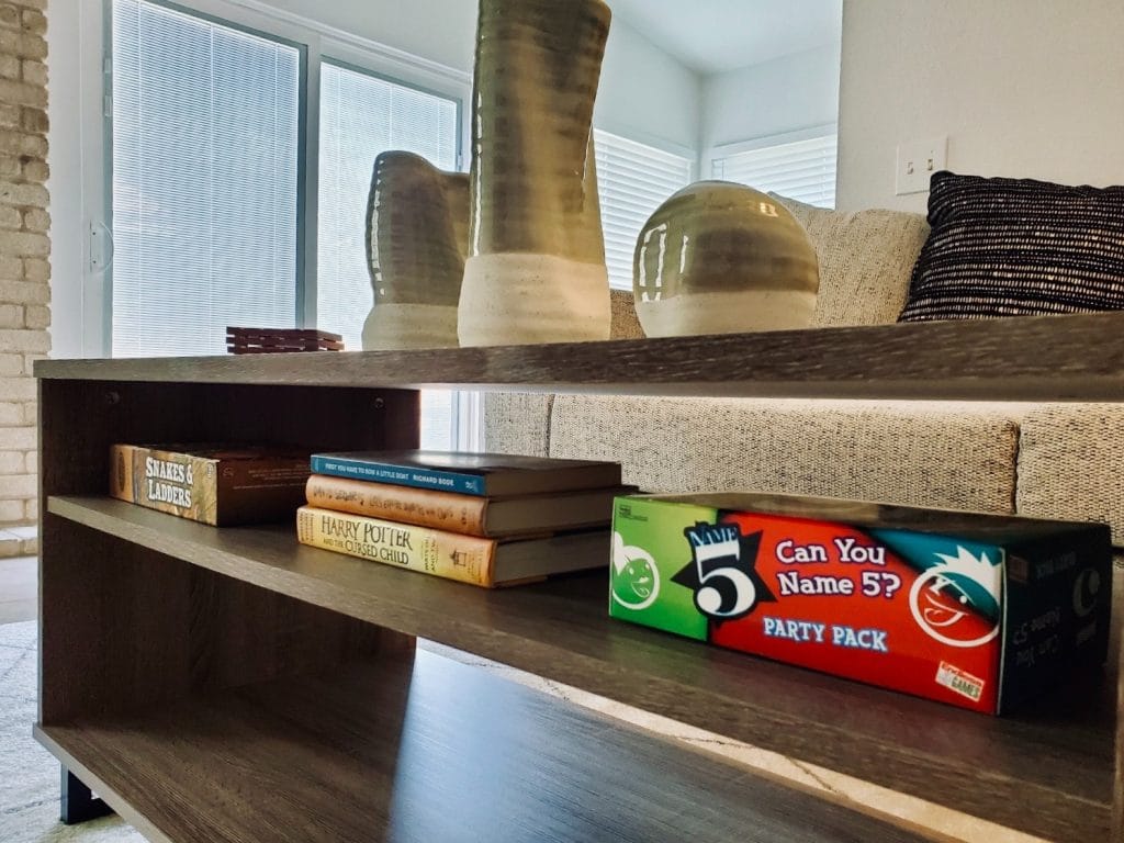 Stylish living area with modern decor, cozy seating, and games for entertainment. Immaculate and inviting ambiance | Dream TDY