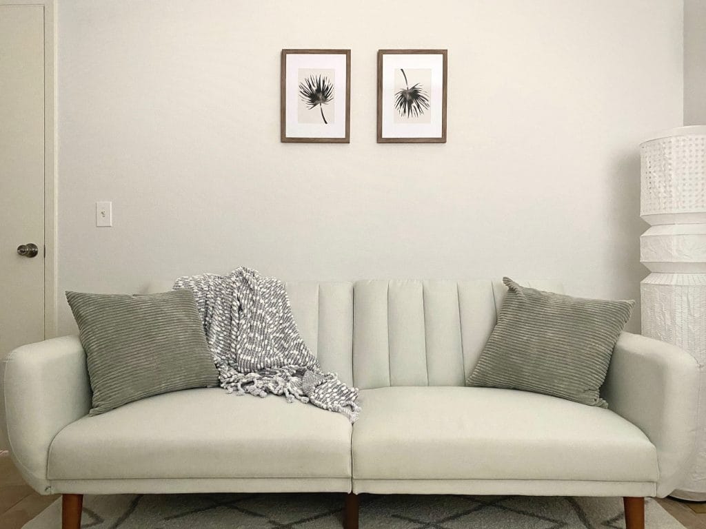 Stylish and clean, this cozy seating area features a modern sofa, soft pillows, and a unique lamp for your comfort | Dream TDY