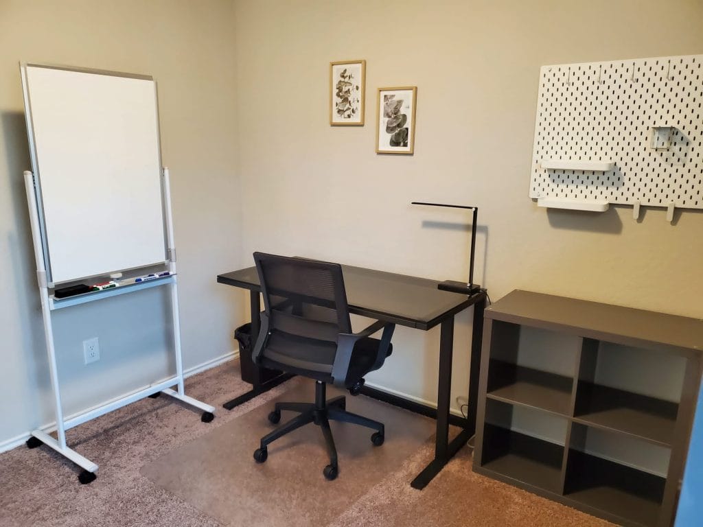 Modern workspace with a desk, ergonomic chair, and whiteboard. Clean and organized, perfect for productive stays | Dream TDY