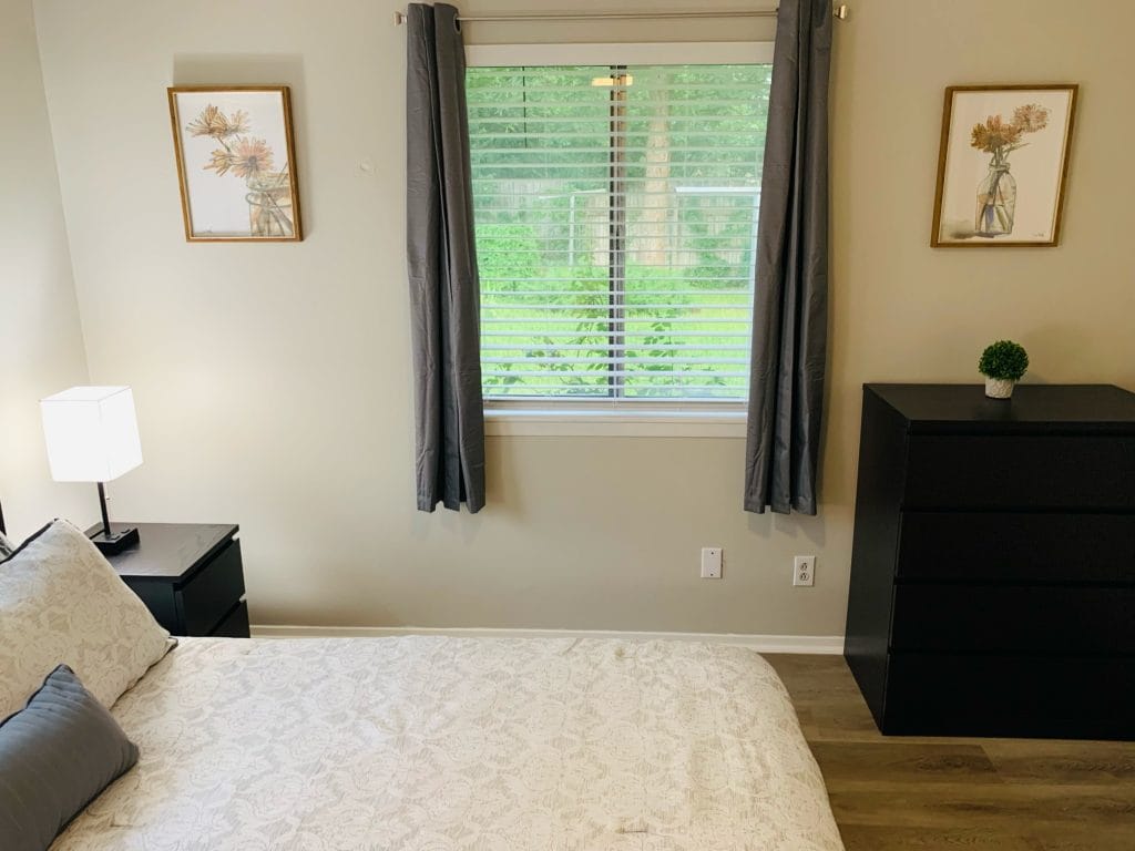 Cozy bedroom with modern decor, comfortable bedding, and natural light. Perfect for a relaxing stay | Dream TDY