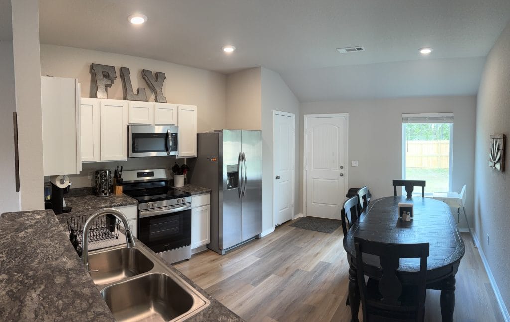 Bright and spacious kitchen with modern appliances, cozy dining space, and clean design—perfect for short-term stays.