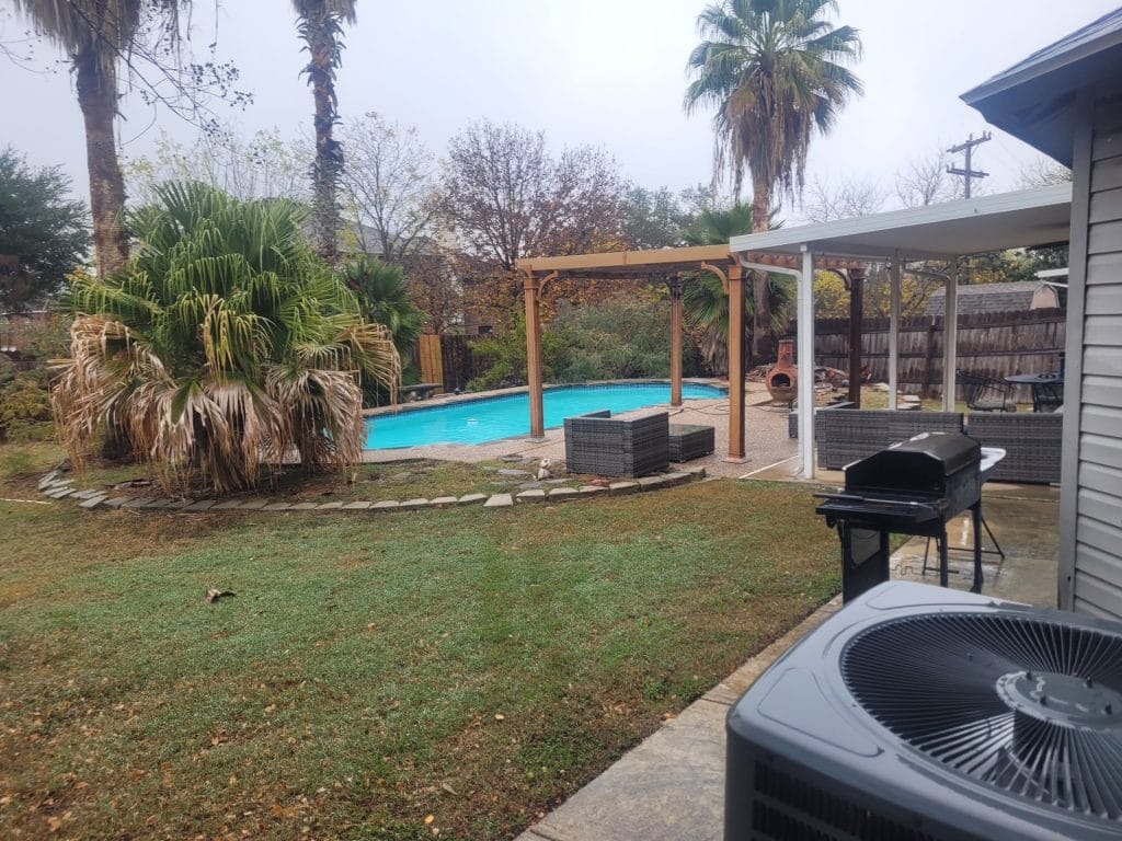 Tranquil outdoor oasis featuring a sparkling pool, cozy seating, and a grill, perfect for relaxation after a day of duty | Dream TDY