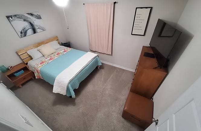 Cozy bedroom with modern decor, a comfortable queen bed, TV, and ample storage. Clean and inviting for a restful stay | Dream TDY