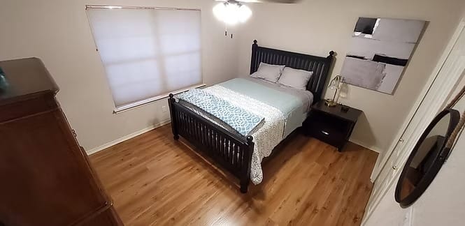 Cozy bedroom with elegant furnishings, hardwood flooring, and ample natural light, perfect for relaxation and rest | Dream TDY