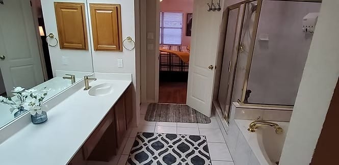 Spacious bathroom with dual sinks, modern fixtures, and elegant decor. Enjoy a relaxing soak and easy access to cozy bedroom | Dream TDY