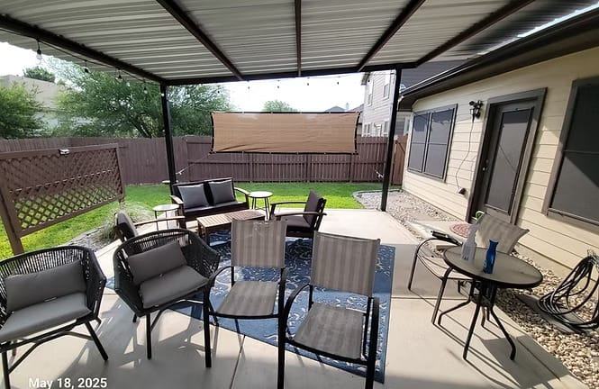 Spacious outdoor patio with comfortable seating, perfect for relaxation. Enjoy the landscaped yard for leisure activities | Dream TDY