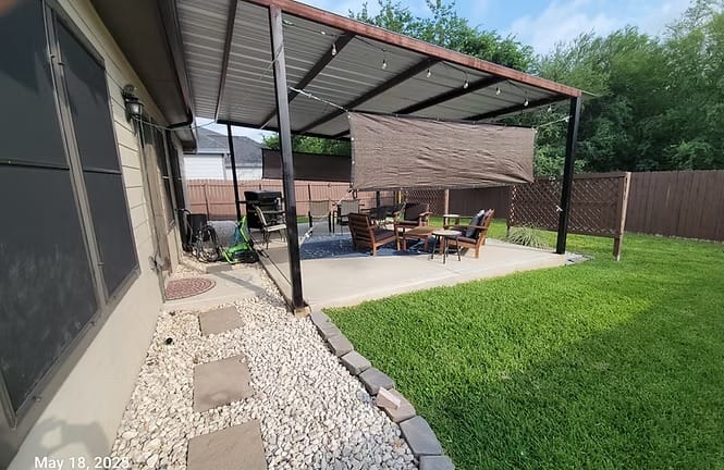 Spacious outdoor living area with comfortable seating, covered canopy, and lush lawn—perfect for relaxation and gatherings | Dream TDY