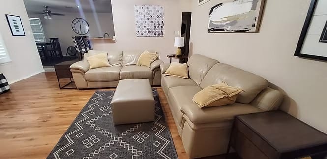 Inviting living space with cozy leather seating, modern decor, and natural light; perfect for relaxation or briefings | Dream TDY