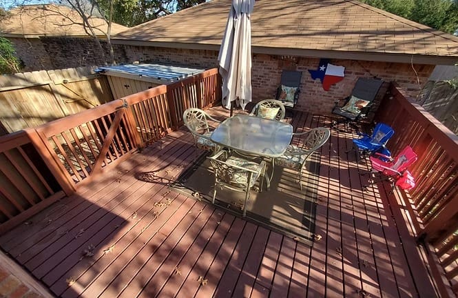 Spacious outdoor deck with patio furniture, perfect for relaxing. Enjoy the shade and Texas charm | Dream TDY