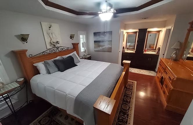 Spacious bedroom with a cozy king bed, stylish decor, and modern en-suite bath. Perfect for a relaxing stay | Dream TDY