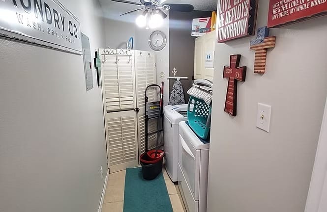 Bright and inviting laundry area with modern appliances, organized storage, and a cozy decor touch | Dream TDY