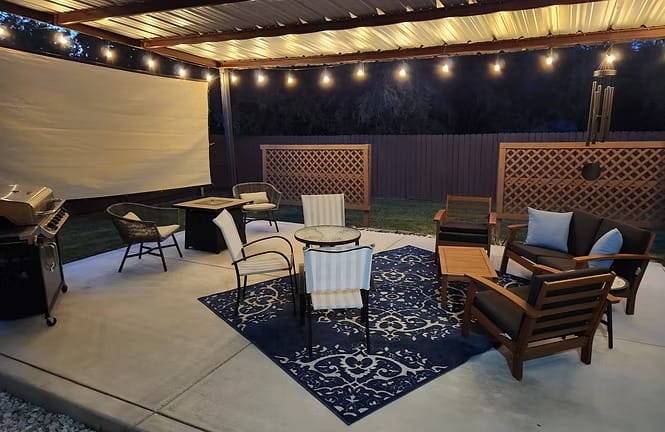 Cozy outdoor space with ambient lighting, comfortable seating, and BBQ grill for relaxing evenings | Dream TDY