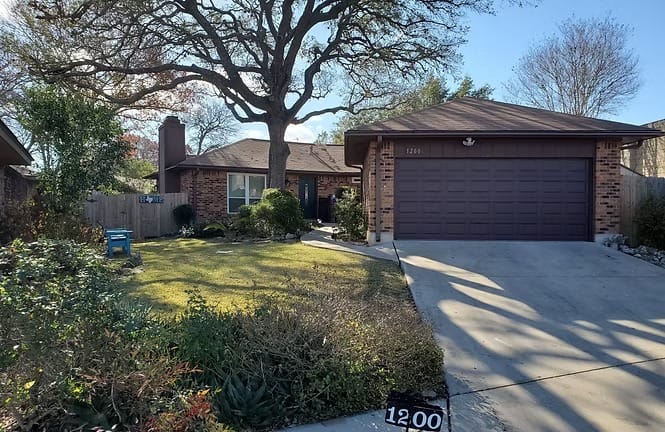 Charming brick exterior with a spacious yard and cozy outdoor seating, perfect for relaxing after a long day | Dream TDY