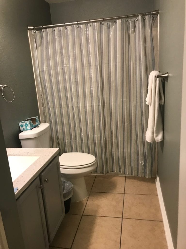 Clean, modern bathroom featuring neutral tones, spacious countertop, and fresh towels for a comfortable stay | Dream TDY