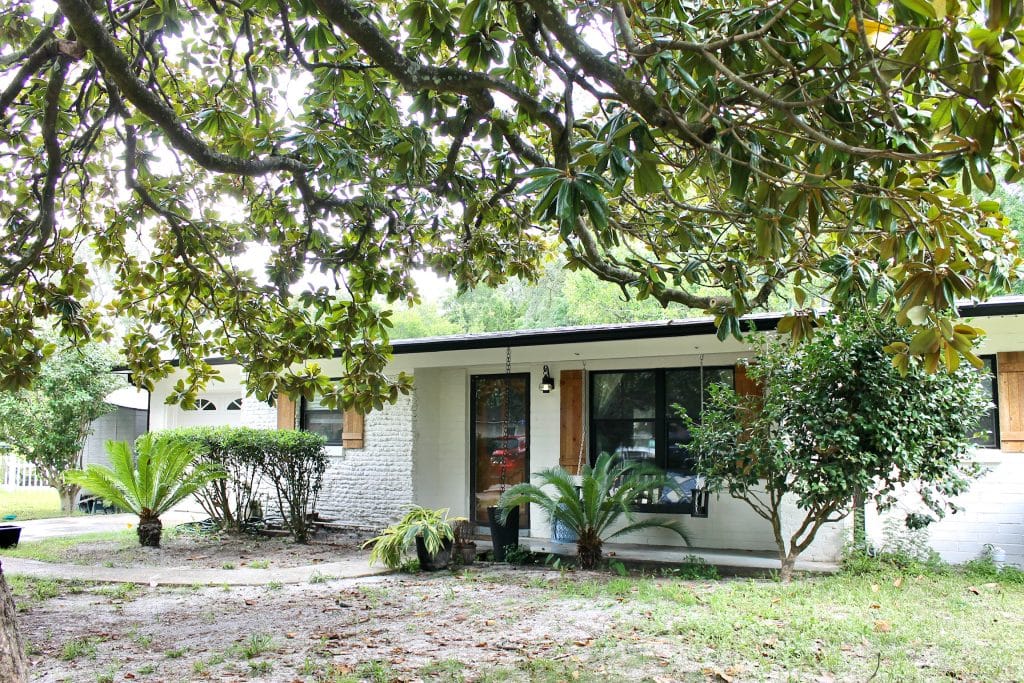 Charming outdoor space with lush greenery, inviting entrance, and ample parking. Perfect for relaxation after duty | Dream TDY