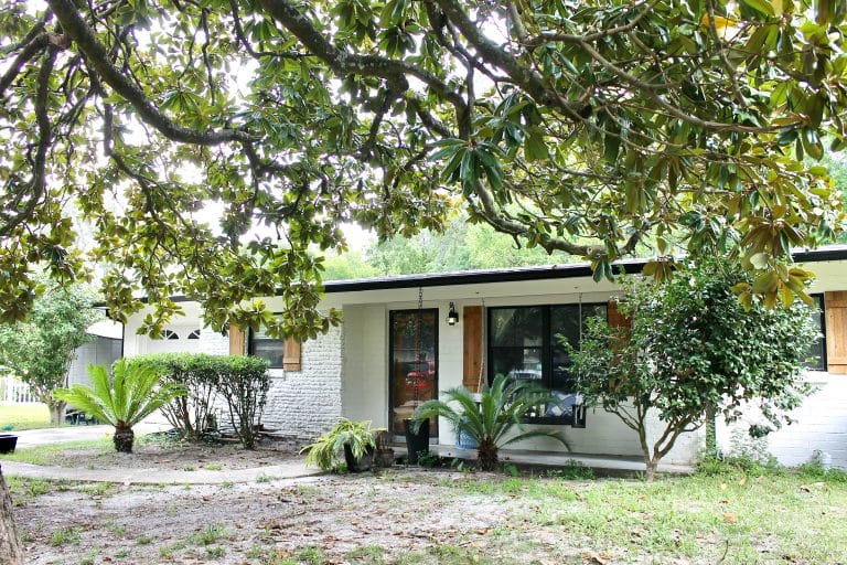 Charming outdoor space with lush greenery, inviting entrance, and ample parking. Perfect for relaxation after duty | Dream TDY