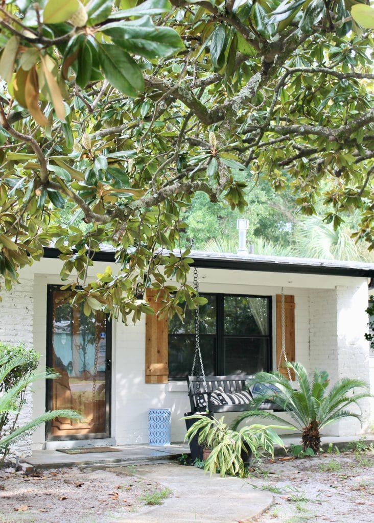 Charming entrance with a swing bench, lush greenery, and a welcoming vibe. Perfect for relaxation and unwinding | Dream TDY
