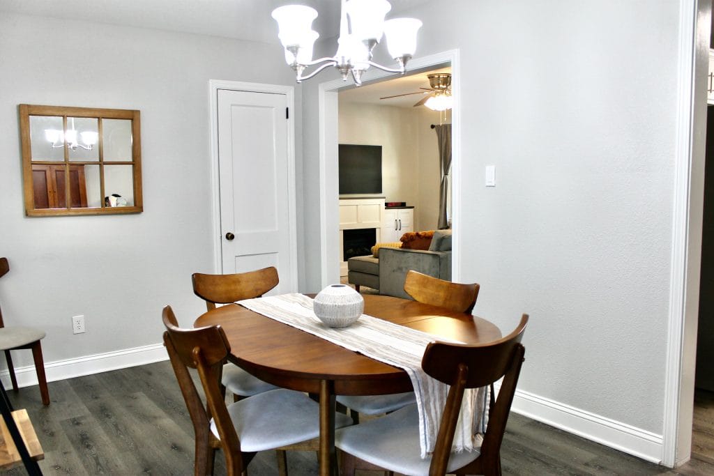 Charming dining area with modern wooden table, cozy chairs, and bright decor. Ideal for meals or work. | Dream TDY
