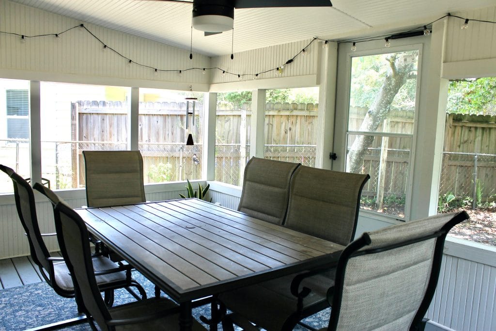Bright and airy sunroom with a spacious dining table, modern seating, and outdoor views for relaxing or work | Dream TDY
