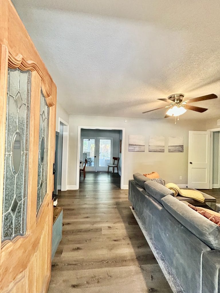 Inviting hallway leads to a cozy living space with modern furnishings, clean aesthetics, and ample natural light | Dream TDY