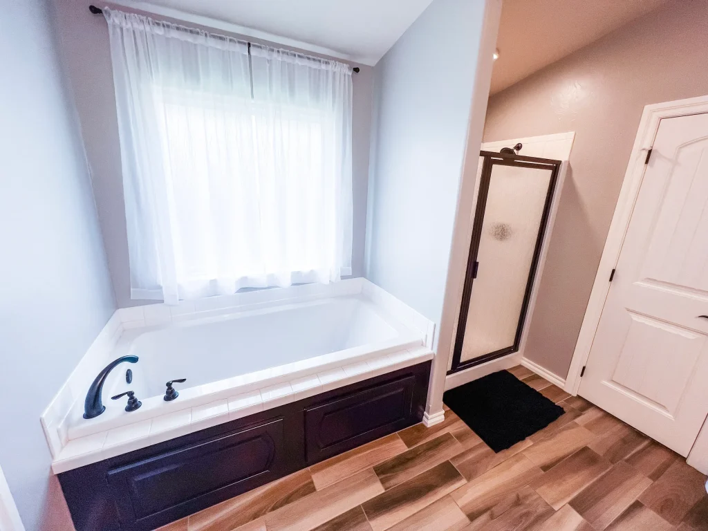Relax in this clean, spacious bathroom featuring a luxurious soaking tub, modern shower, and elegant fixtures | Dream TDY