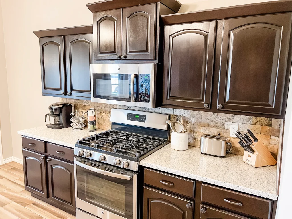 Stylish kitchen featuring dark cabinetry, modern appliances, and a spacious countertop for meal prep| Dream TDY