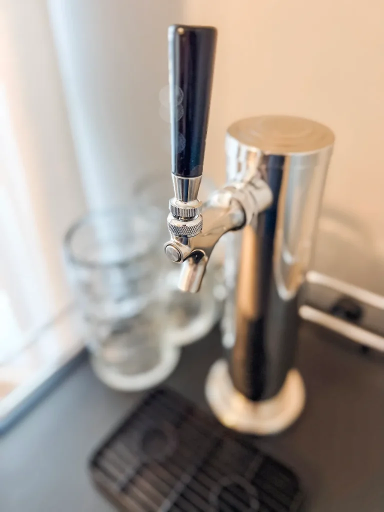 Stylish bar setup with a brewery-grade tap, modern amenities, and glassware—perfect for unwinding after duty hours | Dream TDY