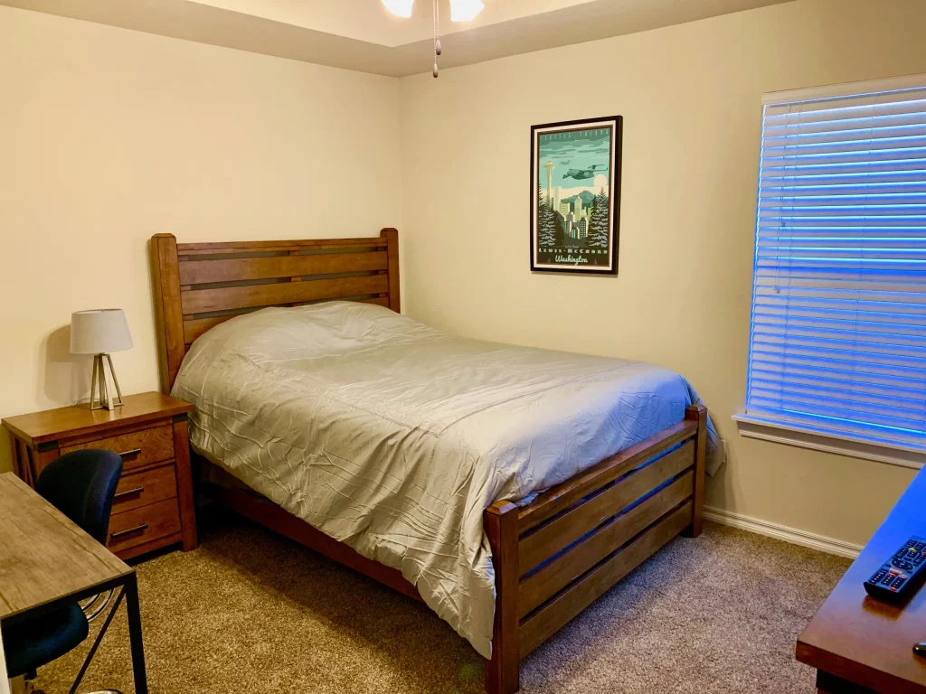 Cozy bedroom featuring a comfortable bed, dedicated workspace, modern decor, and ample natural light | Dream TDY