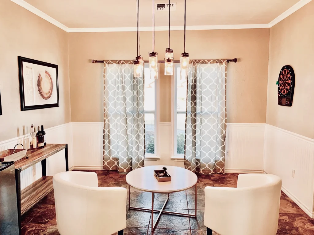 Bright and inviting space with modern decor, cozy seating, dedicated workspace, and amenities like a mini fridge | Dream TDY