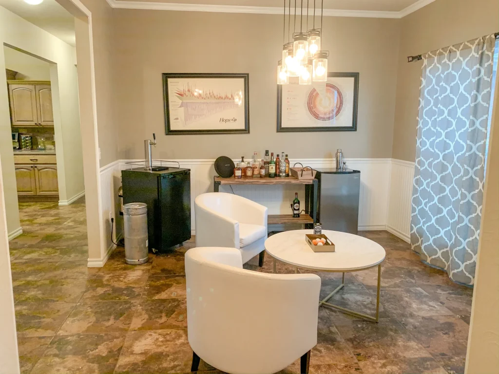 Bright, inviting lounge with modern seating, a mini fridge, and a stylish bar setup, perfect for relaxation | Dream TDY