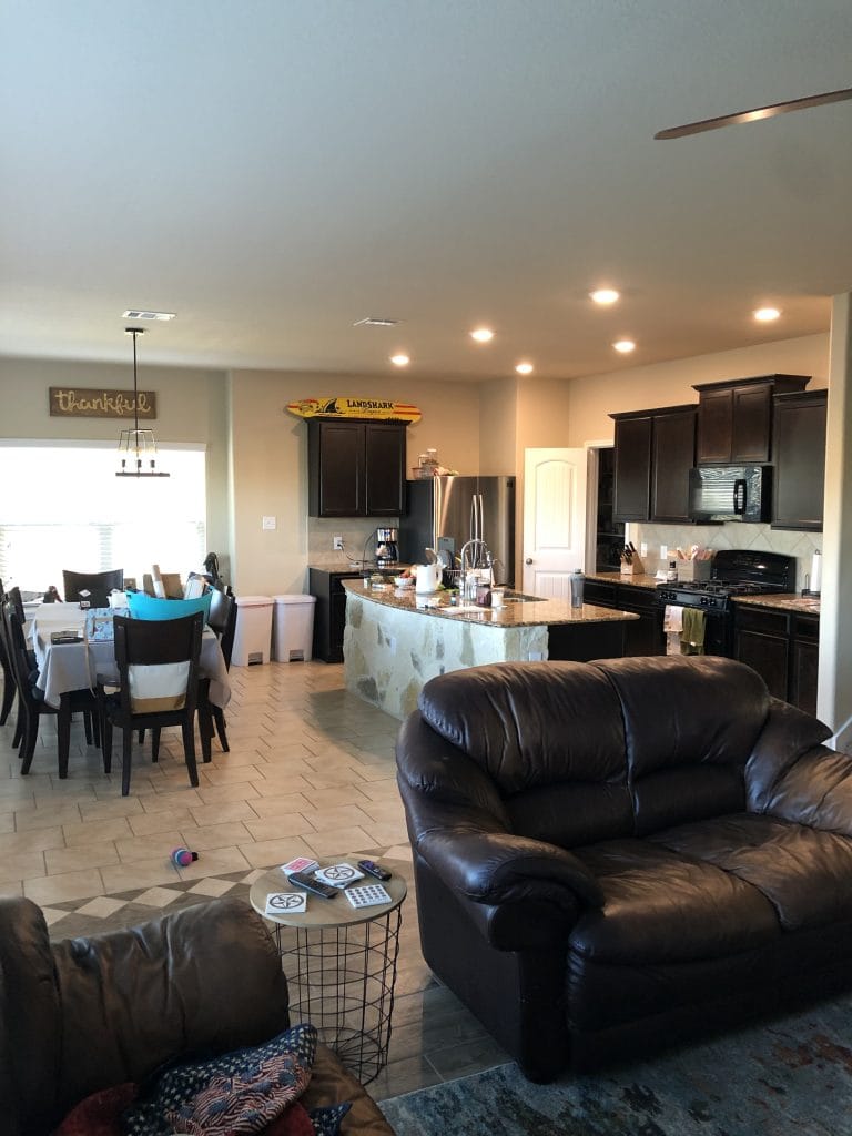 Spacious open floor plan with modern appliances, cozy leather seating, dedicated dining area, and bright natural light | Dream TDY