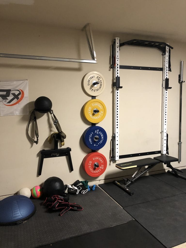 Fully equipped home gym with weights, benches, and fitness accessories for a comprehensive workout experience | Dream TDY
