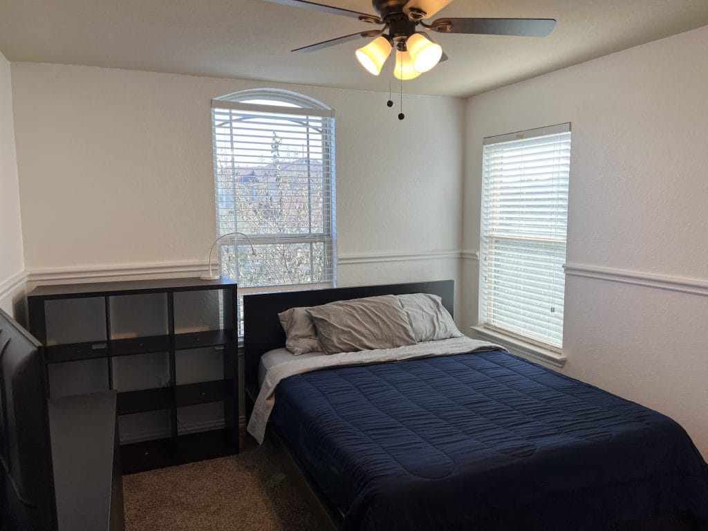 Cozy bedroom with modern decor, a comfortable bed, natural light, and ample storage space for a pleasant stay | Dream TDY