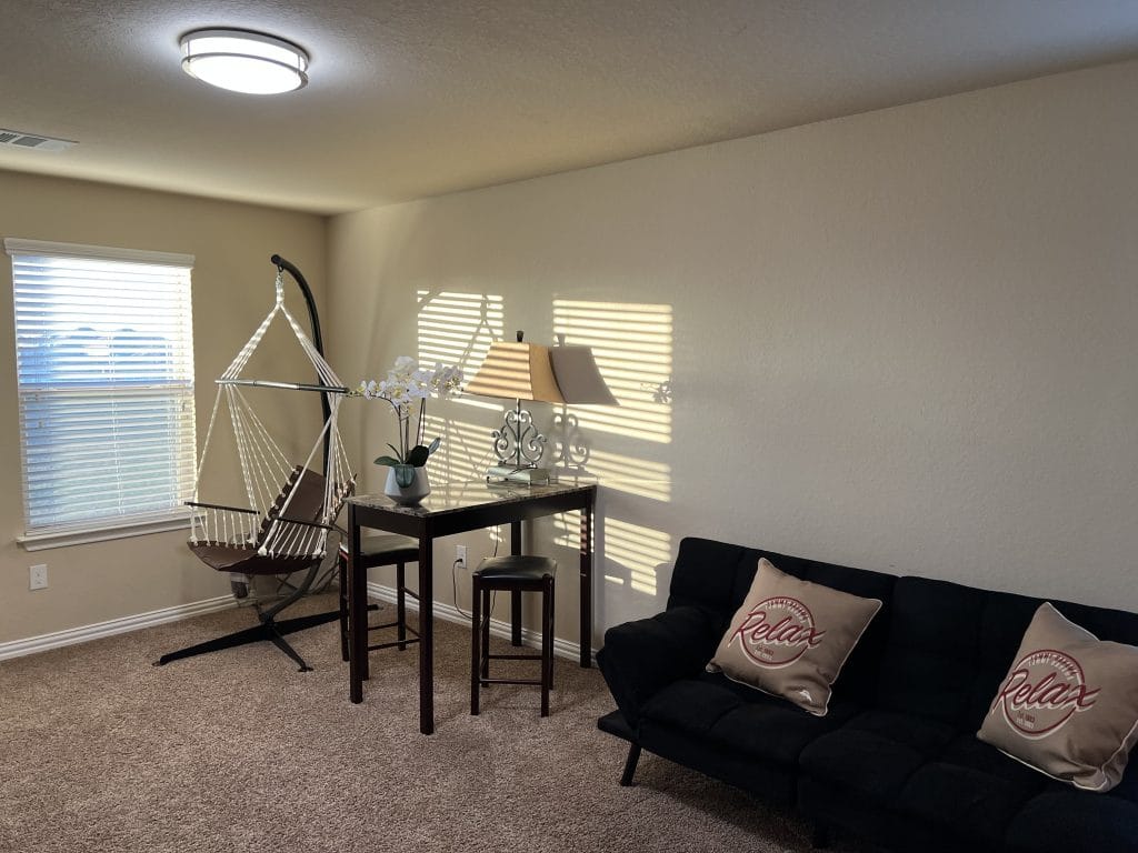 Bright and inviting living space featuring cozy seating, a dedicated workspace, and stylish decor | Dream TDY